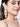 Aatreya Premium Designer Earrings featuring layered cowrie shells, faux pearl accents, handcrafted antique gold detailing, and cascading statement design