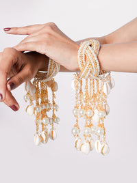 Aatreya Bridal Shell Kaleera featuring cascading cowrie shells, faux pearls and gold tone detailing for bridal, wedding and festive celebrations.