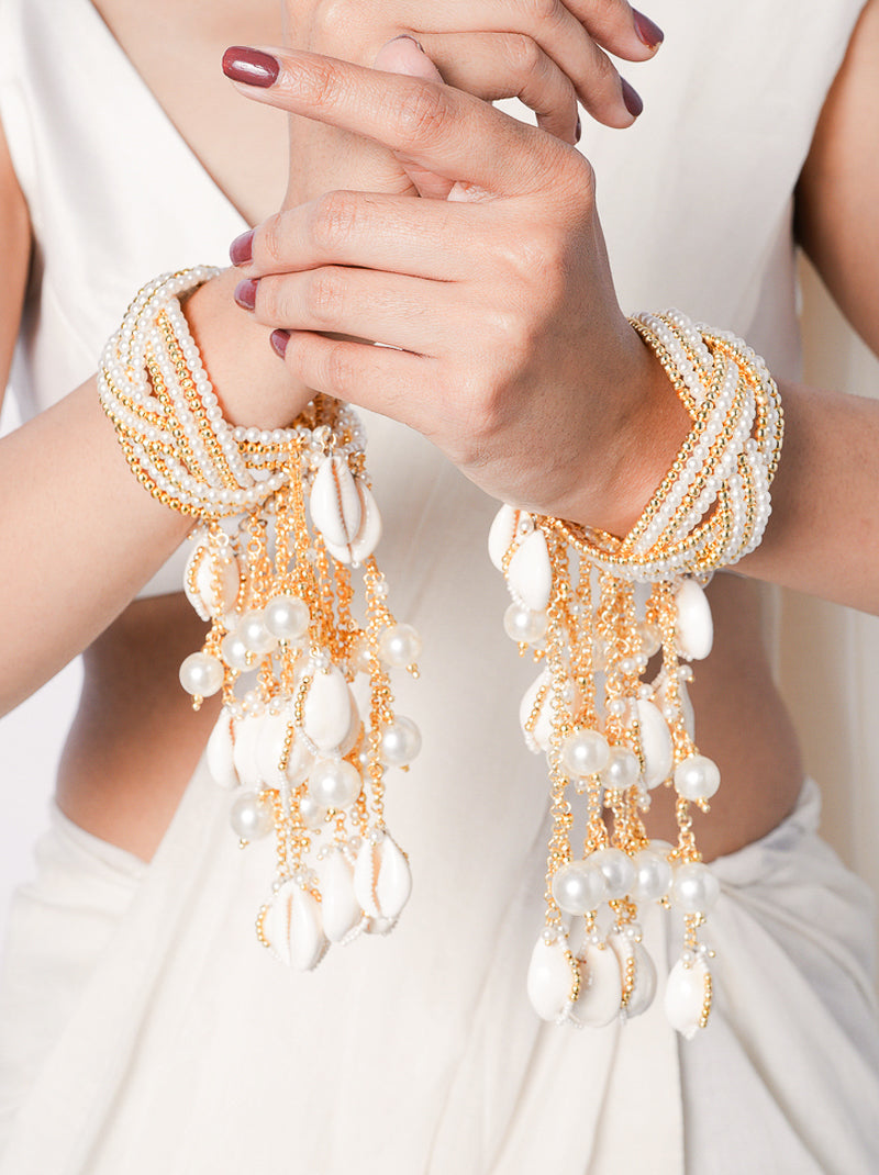 Aatreya Bridal Shell Kaleera featuring cascading cowrie shells, faux pearls and gold tone detailing for bridal, wedding and festive celebrations.