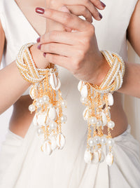 Aatreya Bridal Shell Kaleera featuring cascading cowrie shells, faux pearls and gold tone detailing for bridal, wedding and festive celebrations.