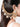 Aadarshini Handmade Shell Earrings featuring handcrafted shell charms, pearl embellishments, cascading ear chain detailing, peach bead accents, and gold tone craftsmanship for bridal wear, festive styling, and statement ethnic fashion.