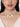 Alaya Cowrie Shell Choker handcrafted with layered faux pearl strands, natural cowrie shell centerpiece, cascading shell drops, intricate glass bead detailing, and a Gold Tone Finish, perfect for Haldi, Mehndi, weddings, receptions, destination weddings, and elegant bridal styling.