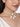 Alaya Cowrie Shell Choker handcrafted with layered faux pearl strands, natural cowrie shell centerpiece, cascading shell drops, intricate glass bead detailing, and a Gold Tone Finish, perfect for Haldi, Mehndi, weddings, receptions, destination weddings, and elegant bridal styling.