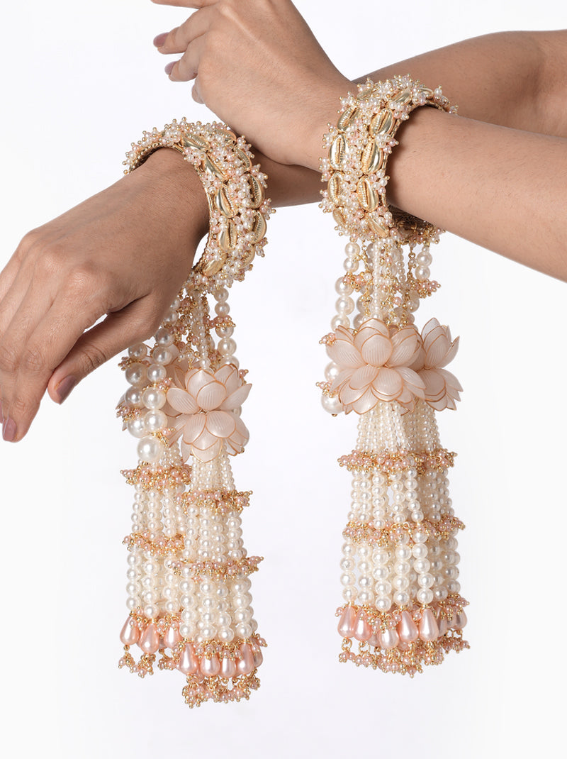 Anika Pearl Bridal Kaleera handcrafted with layered faux pearl tassels, floral accents, intricate glass bead embroidery, decorative bridal bangles, and a Gold Tone Finish, perfect for Haldi, Mehndi, bridal ceremonies, wedding rituals, bridal entry, receptions, and luxurious wedding styling.
