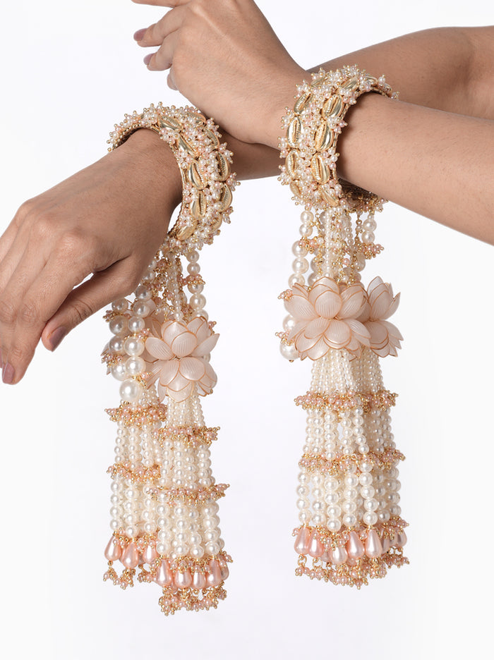 Anika Pearl Bridal Kaleera handcrafted with layered faux pearl tassels, floral accents, intricate glass bead embroidery, decorative bridal bangles, and a Gold Tone Finish, perfect for Haldi, Mehndi, bridal ceremonies, wedding rituals, bridal entry, receptions, and luxurious wedding styling.