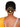 Model wearing Anuradha Metallic Bun Accessory featuring layered concentric brass circles with a floral centrepiece in a contemporary gold tone hair bun design.