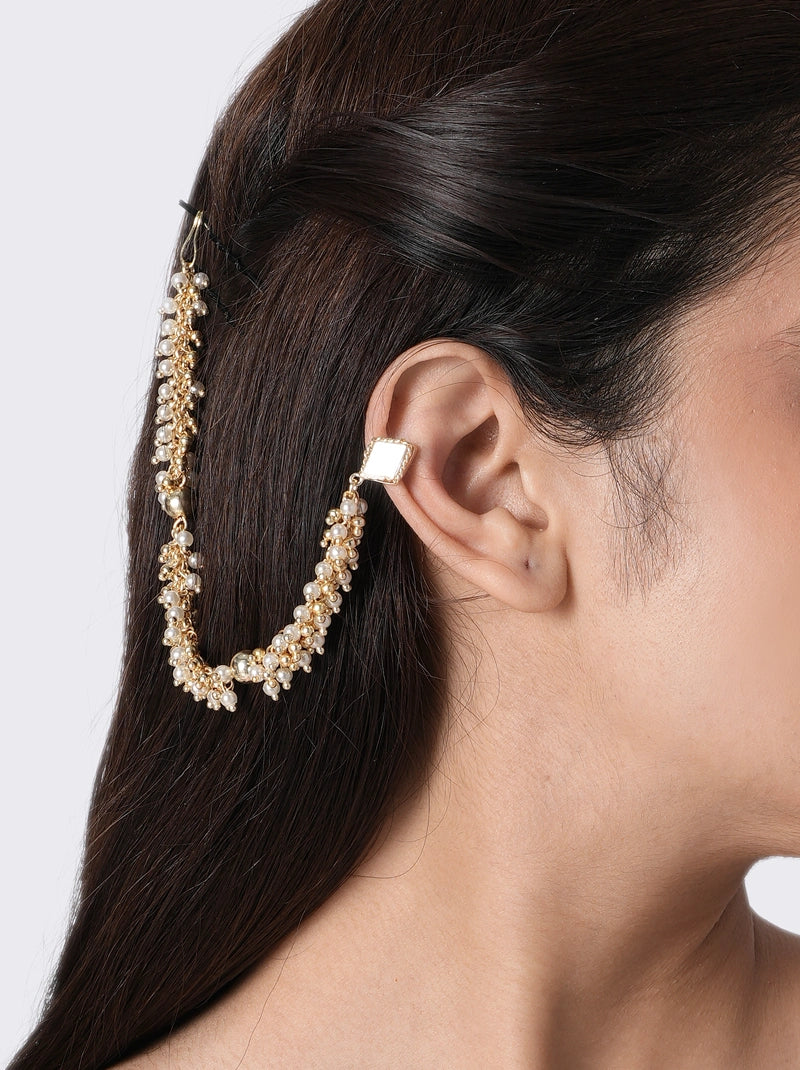 Arya Festive Handmade Earcuff handcrafted with mirror accents, faux pearls, glass beads, and brass metal in a Gold Tone Finish, featuring a draped pearl chain connected to a hair pin for elegant weddings, mehendi, haldi ceremonies, festive occasions, and bridal styling.