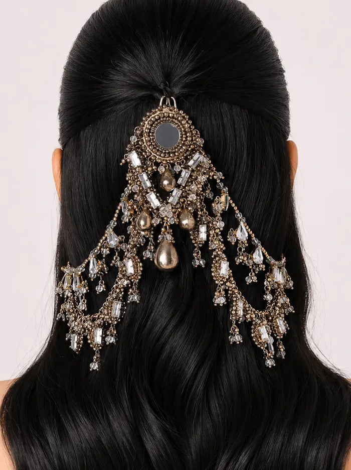 Ashita Embroidery Hair Accessory featuring an antique dual-tone finish, crystal embellishments, mirror-inspired centerpiece and cascading chain drapes for bridal and festive hairstyles.