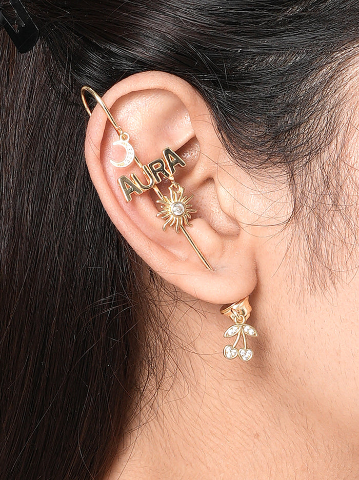 Aura Moodcuff pair handcrafted in brass metal with AURA lettering, crescent moon charm, sun motif with glass stone detailing, and a Gold Tone Finish, perfect for parties, festive occasions, vacations, concerts, and contemporary statement styling.