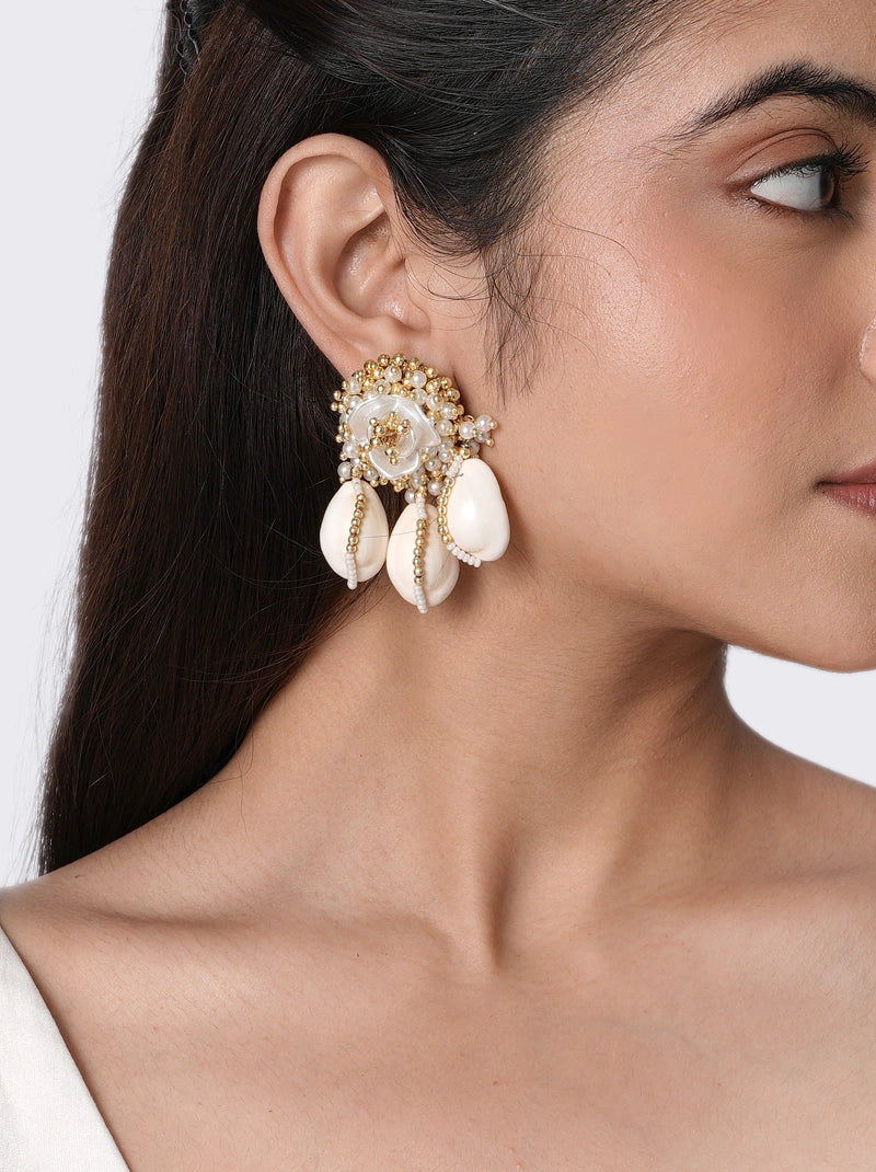 Aurelia Shell Floral Earrings handcrafted with shell petals, faux pearls, glass bead detailing, and brass metal in a Gold Tone Finish, featuring an elegant floral design perfect for haldi ceremonies, beach weddings, festive occasions, vacations, and statement styling.