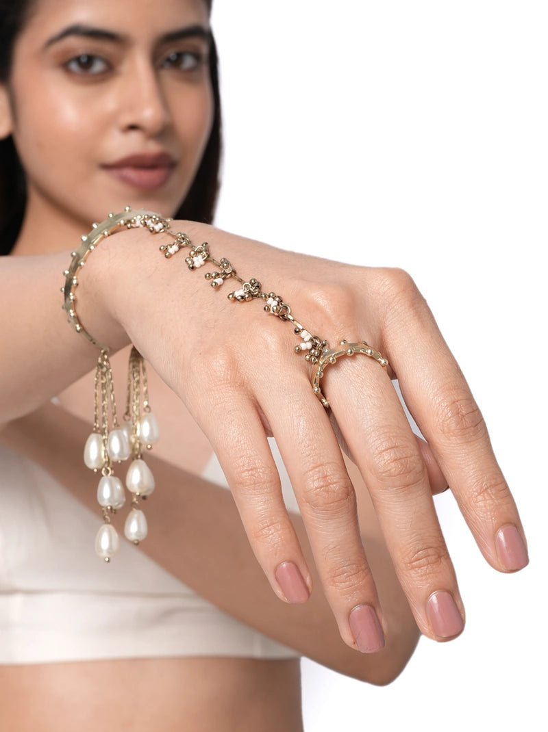 Auri Pearl Chain Haathphool handcrafted with fine brass chains, faux pearls, glass bead accents, and cascading pearl tassels in a Gold Tone Finish, perfect for weddings, haldi, mehendi, festive celebrations, and elegant bridal styling.