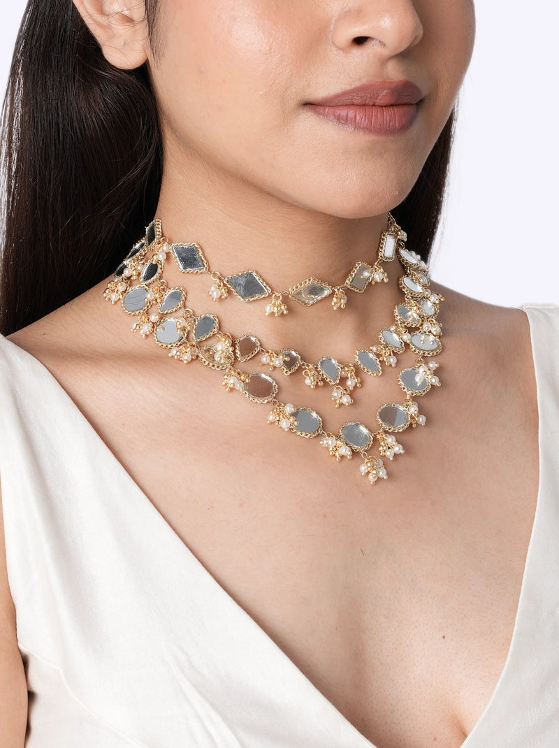 Bhumi Designer Mirror Choker handcrafted with layered geometric and oval mirror motifs, faux pearls, intricate glass bead detailing, brass metal, and a Gold Tone Finish, perfect for weddings, mehendi, haldi, receptions, festive occasions, and contemporary bridal styling.
