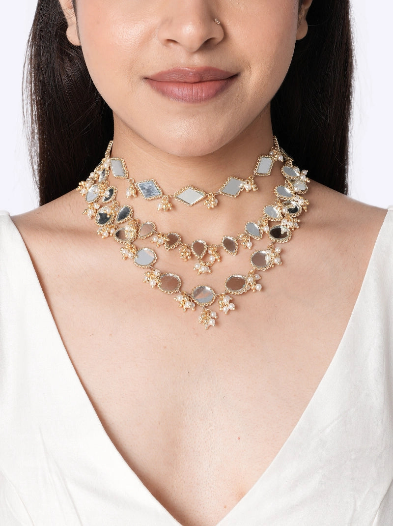 Bhumi Designer Mirror Choker handcrafted with layered geometric and oval mirror motifs, faux pearls, intricate glass bead detailing, brass metal, and a Gold Tone Finish, perfect for weddings, mehendi, haldi, receptions, festive occasions, and contemporary bridal styling.