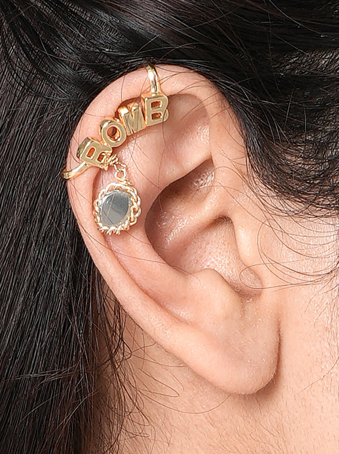 Bomb Moodcuff pair handcrafted in brass metal with bold BOMB lettering, an elegant mirror charm, and a Gold Tone Finish, perfect for parties, birthdays, vacations, festive occasions, and contemporary statement styling.