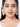 Charvi Floral Shell Earrings featuring cowrie shell floral motifs, faux pearl detailing, ear chain support and a gold tone finish for bridal and festive wear.