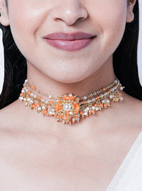 Chitra Floral Pearl Choker handcrafted with floral motifs, pearl embellishments, peach bead detailing, and an elegant gold tone finish for festive and wedding styling.