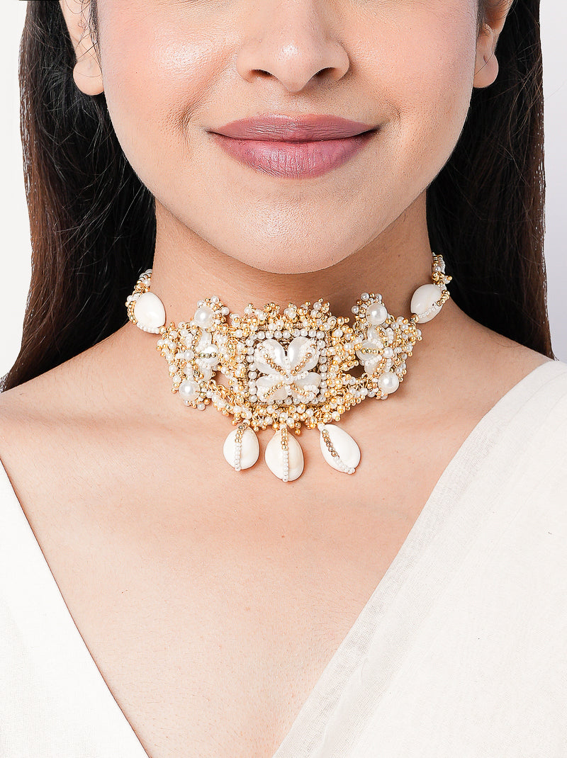 Darika Mehndi Shell Choker featuring cowrie shell centerpiece, faux pearl accents, shell drops and intricate gold tone beadwork for mehendi, bridal and festive wear.