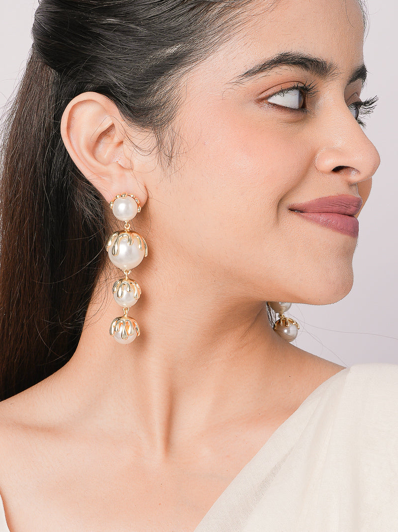 Drip Earrings featuring cascading pearl drops with sculptural gold-tone detailing, statement designer earrings for weddings, festive occasions, and contemporary styling.