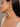 Drip Heart Earrings featuring open heart-shaped gold-tone detailing with cascading pearl accents, statement designer earrings for weddings, festive occasions, and contemporary styling.