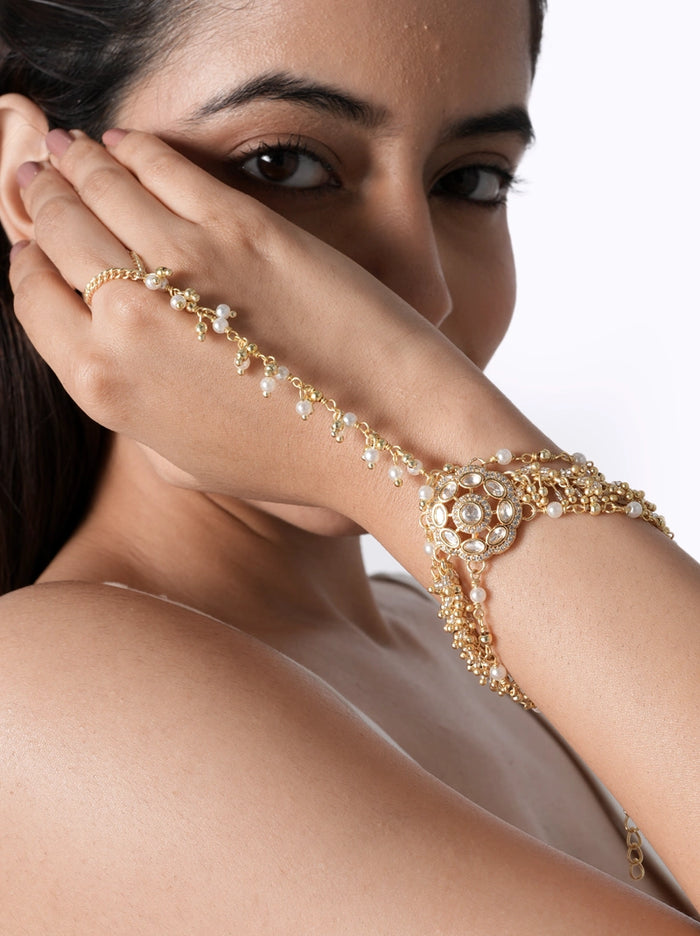 Elara Pearl Designer Haathphool handcrafted with faux pearls, glass stones, brass metal, and cascading pearl chains in a Gold Tone Finish, perfect for bridal wear, weddings, mehendi, haldi, and festive celebrations.