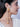 Model wearing Hazel Shell Tassel Earrings featuring natural orange shells, faux pearls and cascading chain tassels with shell drops in a Gold Tone Finish.