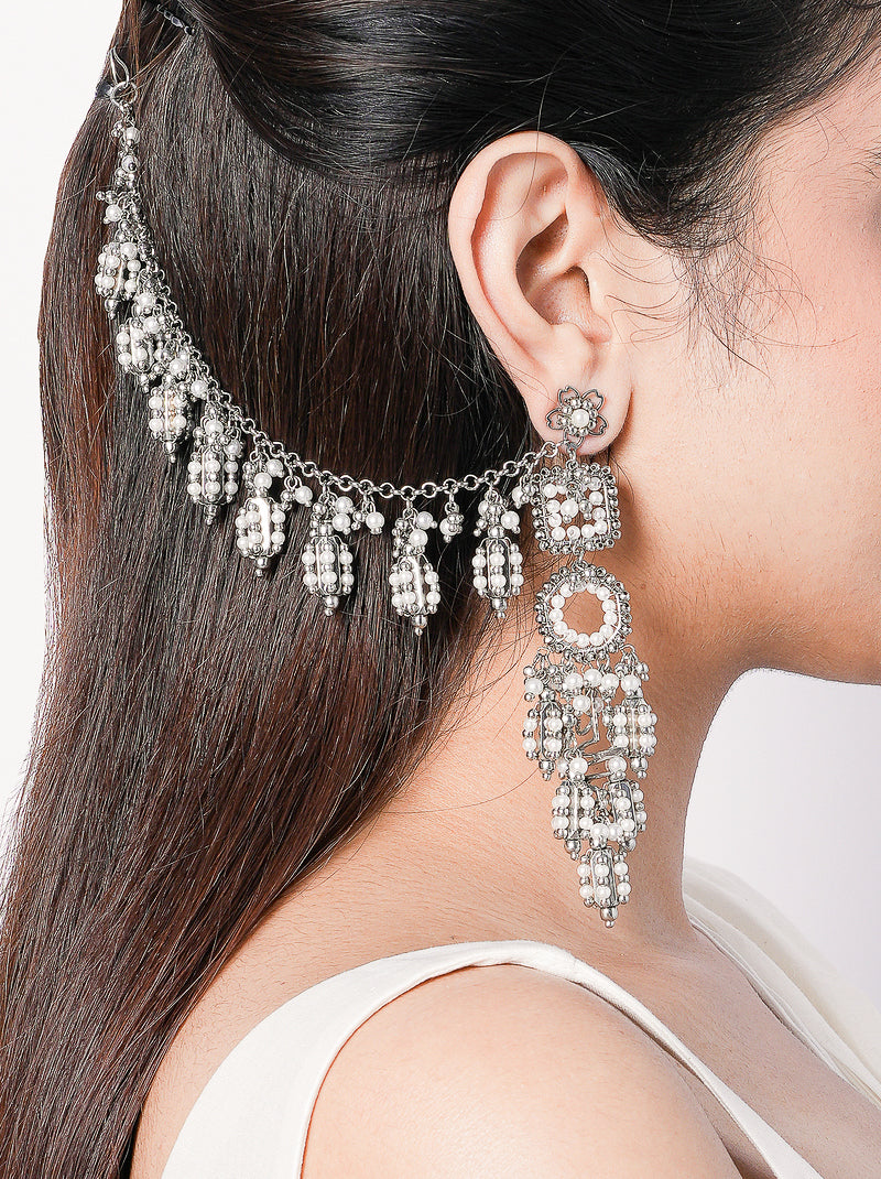 Inaaya handcrafted long silver statement earrings in brass metal with an elegant silver tone finish for weddings, festive occasions, cocktail parties, and contemporary ethnic styling.