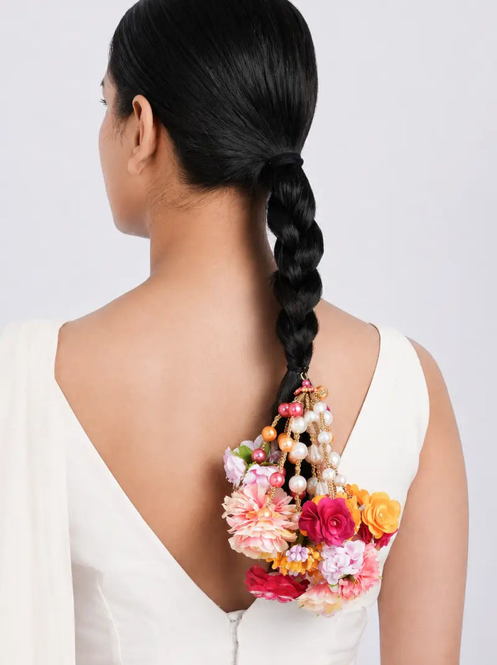 Iravi Floral Bridal Parandi handcrafted with multicolour faux flowers, faux pearls, decorative brass accents and thread tassels, designed for bridal braids, haldi, mehendi, weddings and festive hairstyles.