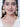 Ishani Floral Statement Earrings featuring handcrafted floral motifs, glass stones, faux pearls, cascading floral bell drops, and antique gold finish designer bridal jewelry.