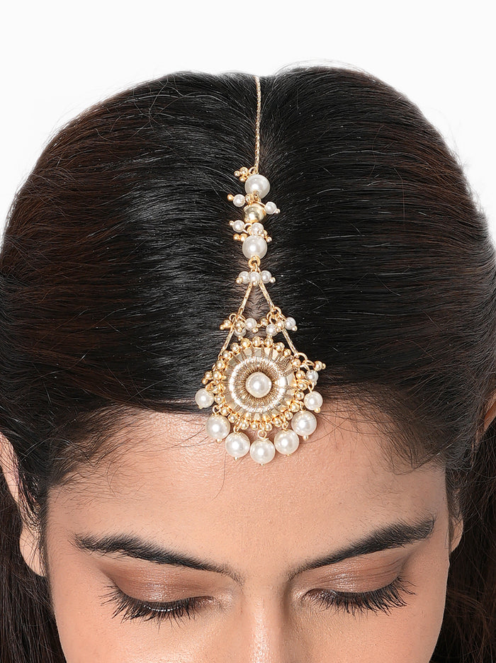 Kanishka Pearl Festive Maangtika handcrafted with a mirror centerpiece, faux pearl drops, intricate glass bead detailing, and a Gold Tone Finish, perfect for Haldi, Mehndi, weddings, receptions, festive celebrations, poojas, and elegant bridal styling.