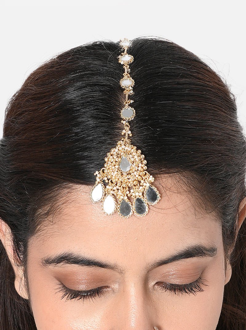 Shop Lisa Mirror Designer Maangtika handcrafted with mirror detailing, glass beads and Gold Tone Finish. Perfect for bridal wear, Haldi, Mehndi and festive occasions.