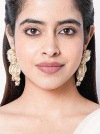 Madhubala Statement Shell Earrings featuring cowrie shell drops, faux pearl accents and intricate gold tone beadwork for bridal and festive wear.