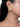 Manyata Pearl Stud Earrings featuring intricate gold-tone beadwork and white faux pearl detailing, styled on a woman.