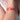 Model wearing Mary Drip Statement Bracelet featuring a sculptural coral red enamel open cuff with contemporary handcrafted artistic design.