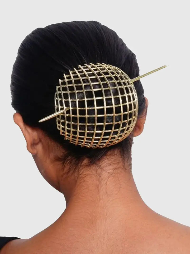 Maze Geometric Bun Cover handcrafted in brass metal with a Gold Tone Finish, featuring a contemporary open-grid cage design secured with a hair stick for elegant bun hairstyles.