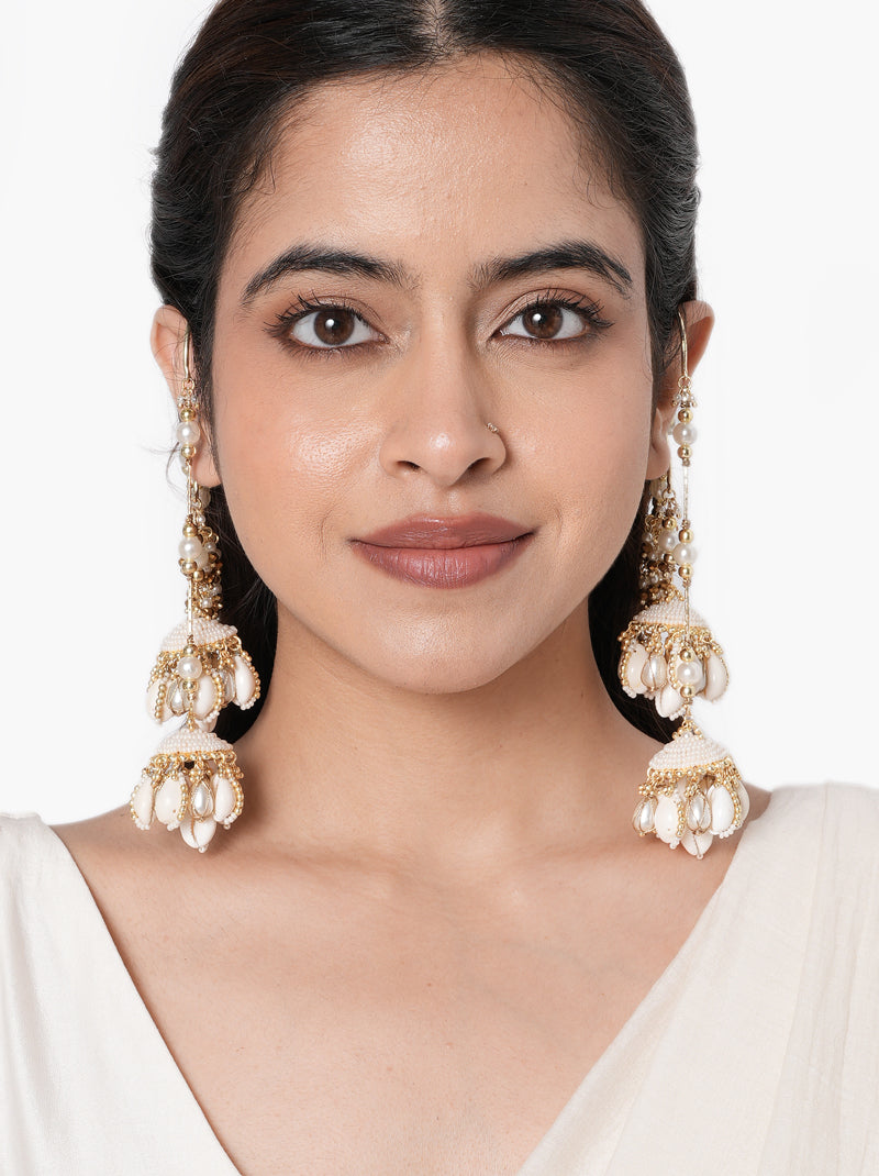Miska Handmade Shell Earrings handcrafted with shell jhumkas, layered pearl earchain, faux pearls, glass beads, and a Gold Tone Finish, perfect for Haldi, Mehndi, weddings, receptions, destination weddings, and luxury bridal styling.