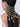 Model wearing Kalavati Beaded Bridal Hairchain featuring cascading antique gold chains, green and orange glass beads, faux pearls and handcrafted jhumka drops for bridal hairstyles.