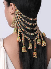Model wearing Kalavati Beaded Bridal Hairchain featuring cascading antique gold chains, green and orange glass beads, faux pearls and handcrafted jhumka drops for bridal hairstyles.