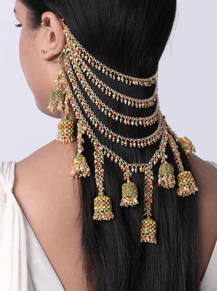 Model wearing Kalavati Beaded Bridal Hairchain featuring cascading antique gold chains, green and orange glass beads, faux pearls and handcrafted jhumka drops for bridal hairstyles.