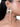 Navi Designer Mirror Earrings featuring geometric mirror accents, white swan-inspired detailing and pearl drops, styled on a woman.
