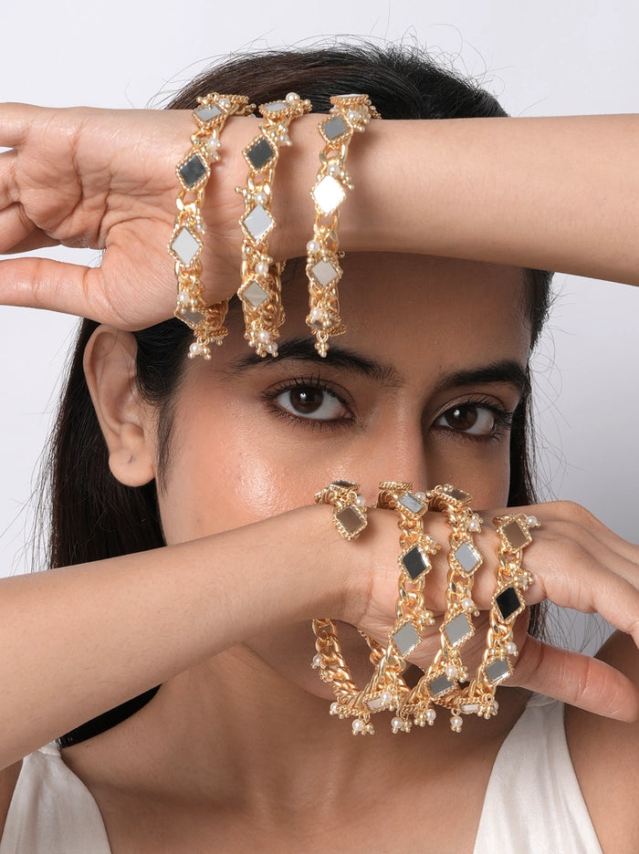 Nehal Mirror Ethnic Bangles handcrafted with mirror accents, faux pearls, glass beads, and brass metal in a Gold Tone Finish, featuring a statement slip-on bangle set perfect for weddings, haldi ceremonies, mehendi celebrations, festive occasions, and ethnic styling.