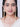 Nyra Bridal Statement Earrings featuring embroidered antique gold motifs, sparkling glass stones, faux pearls, cascading handcrafted jhumki drops, and premium designer bridal styling.
