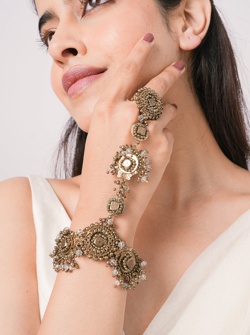 Handcrafted Oorja Imperial Mirror Haathphool featuring brass metal, mirror accents, glass stones and intricate bead detailing with an elegant Antique Finish for bridal and festive wear.