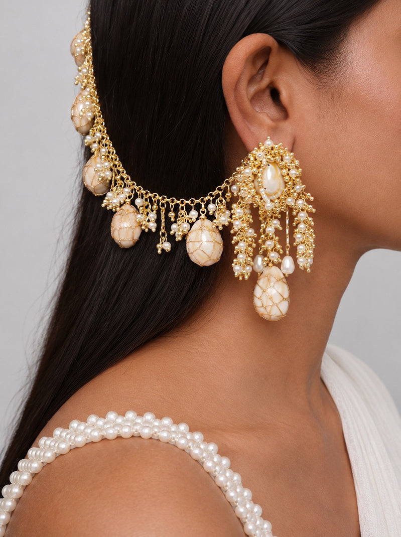 Handcrafted pearl beaded bridal earrings with cascading gold chains and ivory shell accents for haldi and festive styling.