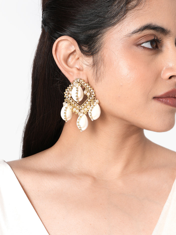 Reeva Handmade Cowrie Earrings handcrafted with natural cowrie shells, faux pearls, intricate glass bead embroidery, and a Gold Tone Finish, creating elegant statement earrings perfect for Haldi, Mehndi, weddings, receptions, destination weddings, festive celebrations, and ethnic styling.