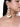 Roja Long Pearl Earrings featuring intricate gold-tone beadwork, pearl detailing and cascading ivory seashell-inspired danglers, styled on a woman.