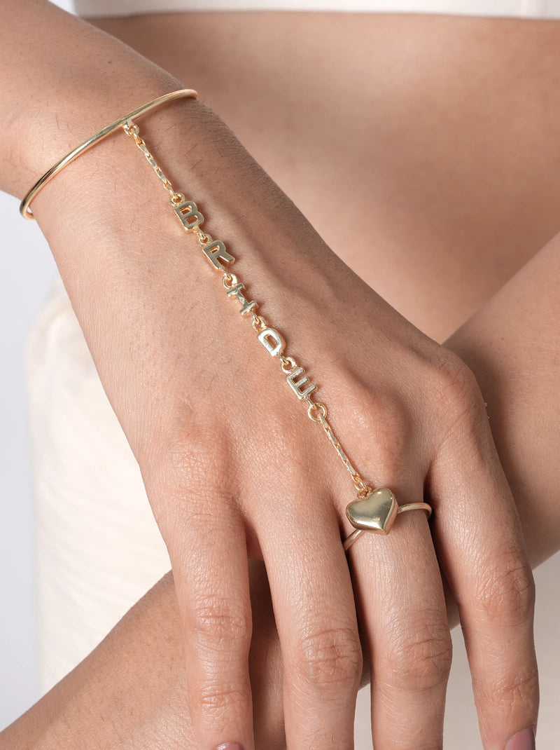 Samaira Bridal Heart Haathphool handcrafted in brass metal with a Gold Tone Finish, featuring a custom name chain, heart ring, and open bangle, perfect for weddings, gifting, bridesmaids, and everyday wear.
