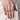 Model wearing Satvik Minimal Crystal Ring featuring baguette, marquise and round glass stones in a silver tone adjustable contemporary ring design.