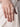 Model wearing Satvik Minimal Crystal Ring featuring baguette, marquise and round glass stones in a silver tone adjustable contemporary ring design.