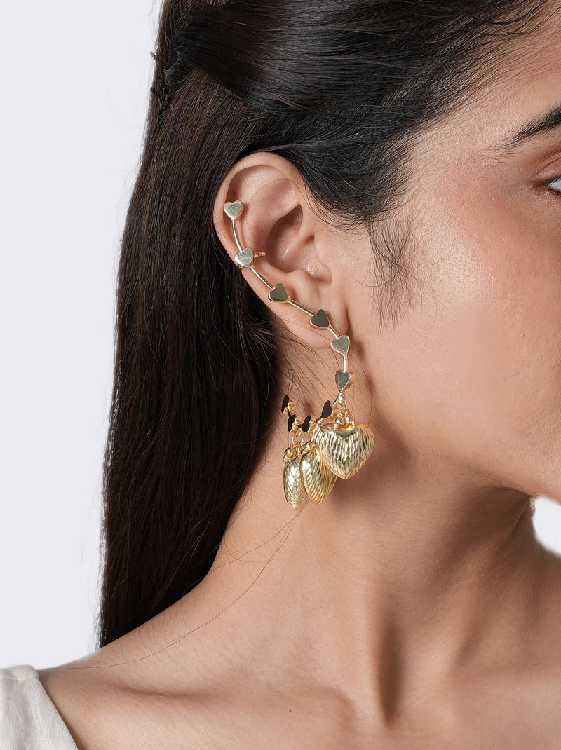 Serena Heart Charm Earring handcrafted in brass metal with a Gold Tone Finish, featuring a heart-inspired ear cuff design with elegant dangling heart and leaf charms, perfect for parties, weddings, festive occasions, vacations, and contemporary styling.