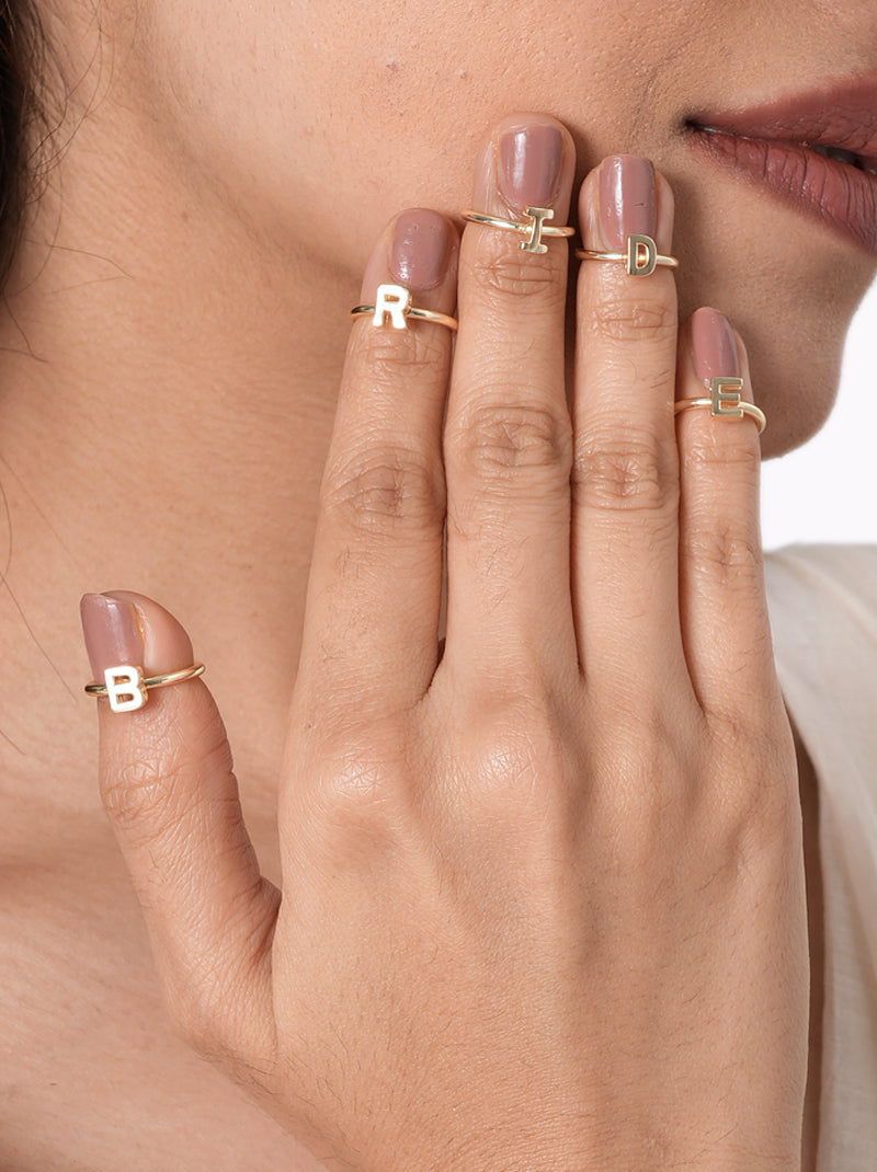 Shalini BRIDE Initial Rings featuring adjustable alphabet rings spelling "BRIDE" with a polished Gold Tone Finish, perfect for bridal showers, bachelorette parties, Haldi, Mehndi, wedding photoshoots, engagement celebrations, and modern bridal styling.